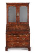 A George I walnut and featherbanded bureau bookcase