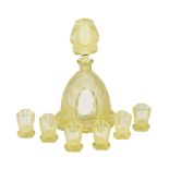 A Czechoslovakian yellow glass annagelb press-moulded and frosted glass spirit set, circa 1960,