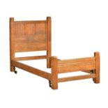 An Arts & Crafts oak Cotswold School single bed, circa 1910, probably by Heals or Liberty, the