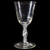 An opaque-twist wine glass, circa 1760, the round funnel bowl with a hammered flute basal section,