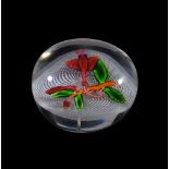 A St. Louis glass 'Fuchia' paperweight, 19th century, the clear glass set with a fuchia flower and a