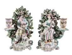 A pair of Derby porcelain figural candlesticks of a shepherd and companion, circa 1770, modelled