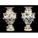 A pair of Meissen (outside decorated) flower and fruit encrusted ozier-moulded baluster vases,