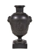 A Humphrey Palmer black basalt vase, circa 1775, the domed shoulder with dentil border suspending
