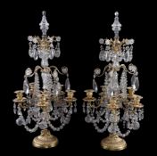 A pair of cut glass and gilt metal five light candelabra in Louis XV style