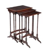 A nest of three Edwardian fiddle-back mahogany and ebonised tables in Regency style