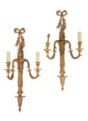 A pair of Continental giltwood twin light wall appliques in Louis XVI style