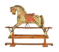 A painted wood and composition rocking horse