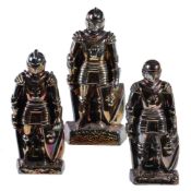 Three enamelled iron fireside companion stands cast as standing knights
