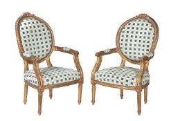 A pair of French giltwood armchairs in Louis XVI style