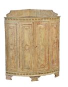 A Continental painted pine corner cupboard