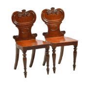 A pair of William IV mahogany hall chairs