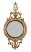 A carved giltwood convex wall mirror in Regency style