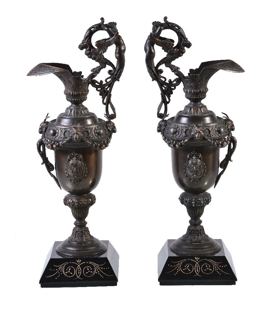 A pair of French patinated metal and marmo nero Belgio mounted ewers in Renaissance Revival taste