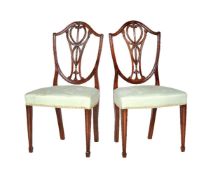 A set of eight mahogany shield back dining chairs in George III style