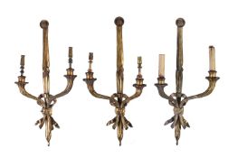 A set of three gilt metal twin light wall appliques in Louis XVI style