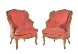 A pair of carved giltwood and red velvet upholstered armchairs in Louis XV style