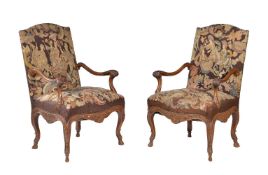 A pair of carved walnut and tapestry upholstered armchairs