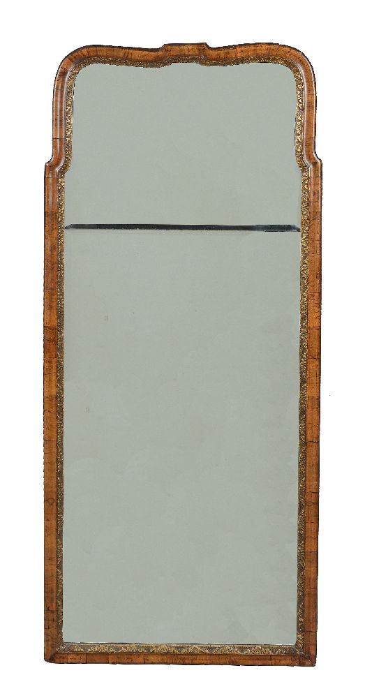 A walnut and parcel gilt wall mirror