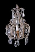 A cut glass and wrought metal three light chandelier in Louis XV taste