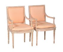 A pair of limed beech open armchairs in Louis XVI style