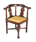 A George III fruitwood corner armchair