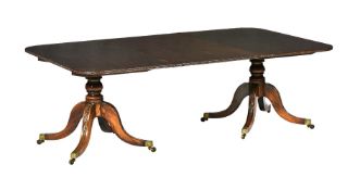 A mahogany twin pillar dining table in George III style