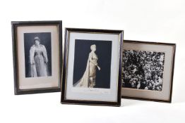A collection of framed photographs, including an official portrait photograph of Queen Mary signed a
