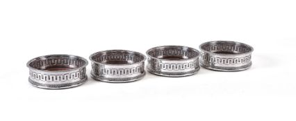 A set of four George III silver bottle coasters by John Roberts & Co., Sheffield 1806