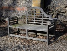 A pair of teak garden benches in the manner of designs by Lutyens