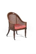 A George IV stained beechwood bergere library armchair, circa 1825