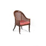 A George IV stained beechwood bergere library armchair, circa 1825