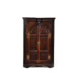 A George III oak standing corner cupboard