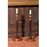 A pair of George III mahogany candle sticks