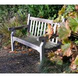 A pair of teak garden benches