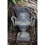A cast iron twin handled garden urn