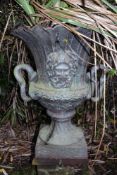 A cast iron twin handled garden urn