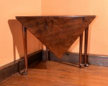 A George III mahogany folding corner table