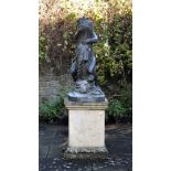 A patinated metal model of a boy holding a dolphin