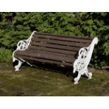 A white painted cast iron and slatted wood garden bench