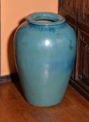 A large turquoise-glazed stoneware vase