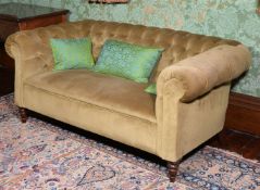 A mahogany and button upholstered sofa