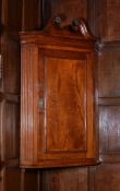 A George III mahogany corner cupboard