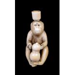 ϒ SHUGYOKU: A Japanese Ivory Netsuke carved as a monkey seated gripping a double-gourd