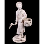 ϒ A Large Japanese Ivory Okimono of a Farmer with Rake