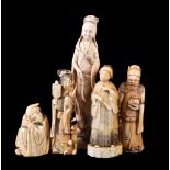 ϒ A Japanese Walrus Ivory Okimono of a standing woman wearing a long dress and holding a fan