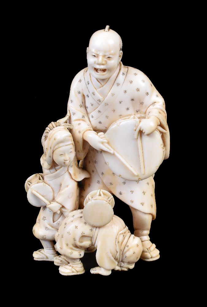 ϒ IKKOSAI: A Japanese Ivory Okimono of a man and his two children as street performers