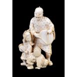 ϒ IKKOSAI: A Japanese Ivory Okimono of a man and his two children as street performers