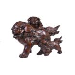 A Japanese Hinoki () Wood Sculpture of a mother shishi striding along with her two cubs