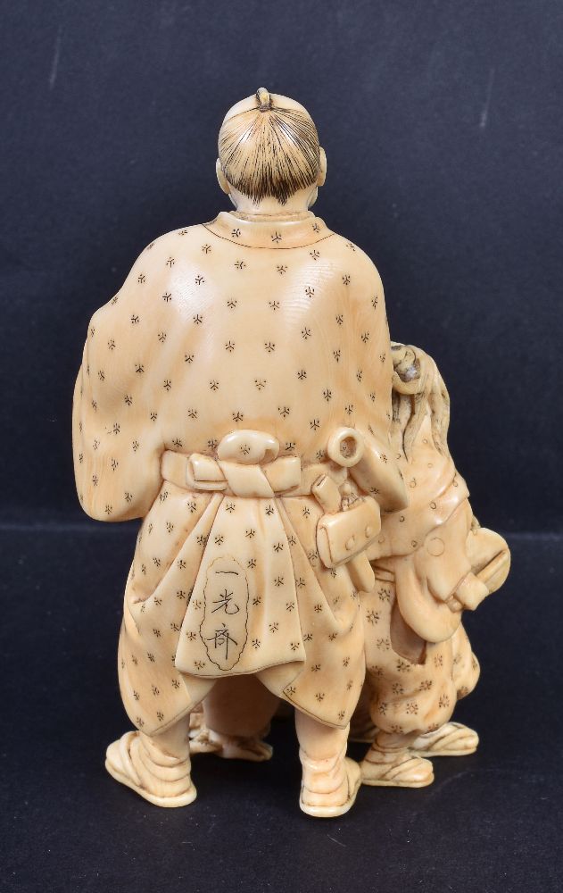 ϒ IKKOSAI: A Japanese Ivory Okimono of a man and his two children as street performers - Image 3 of 4